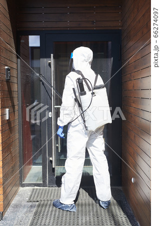Worker Disinfecting Door 66274097