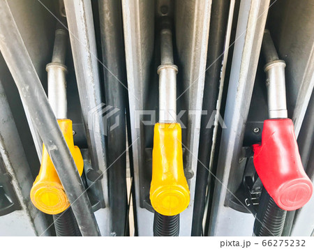 Filling colorful guns at a gas station 66275232