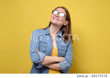 Pretty caucasian woman in glasses isolated over a yellow background 66275578
