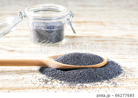 poppy seeds in a wooden spoon and open glass jar poppy seeds in a wooden spoon and open glass jar 66277685