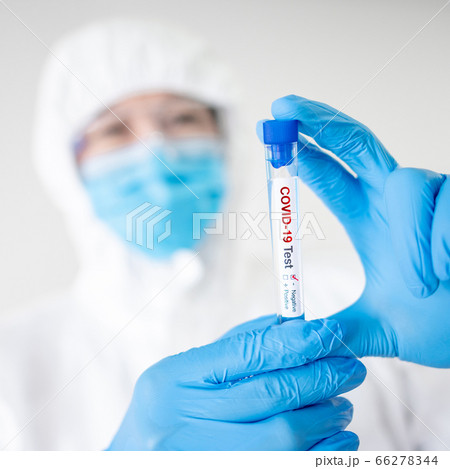 Medical scientist holding COVID-19 Test tube 66278344