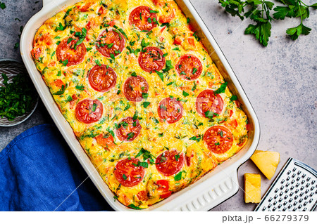 Traditional egg frittata with tomatoes and cheese Traditional egg frittata with tomatoes and cheese 66279379