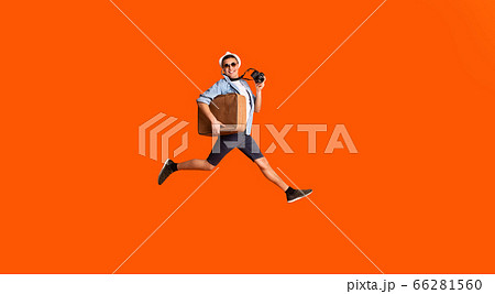 Happy photographer with suitcase running fast over orange background 66281560