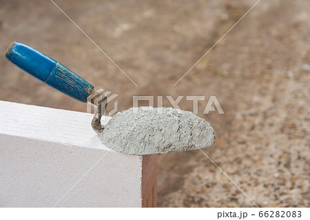 Cement powder or mortar with trowel put on the Cement powder or mortar with trowel put on the 66282083