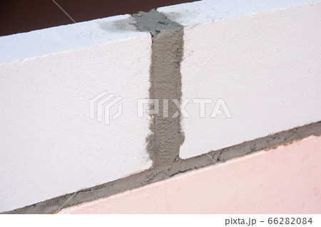 Bricklayer worker installing Lightweight Concrete Bricklayer worker installing Lightweight Concrete 66282084