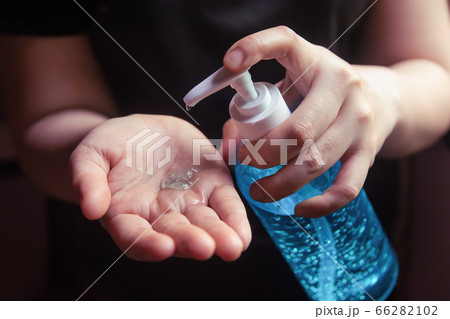 Woman using alcohol gel for cleaning hands 66282102