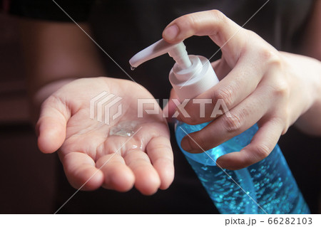 Woman using alcohol gel for cleaning hands 66282103