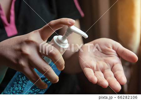 Woman using alcohol gel for cleaning hands Woman using alcohol gel for cleaning hands 66282106