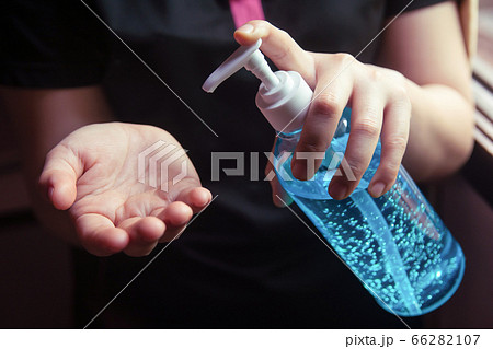 Woman using alcohol gel for cleaning hands 66282107