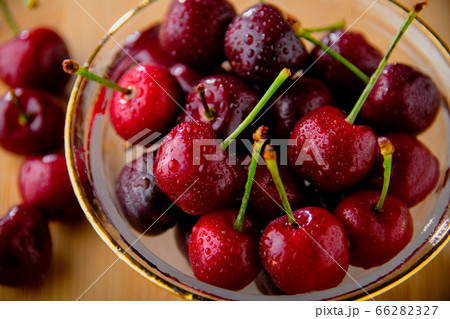 Ripe red cherries in glass bowl. 66282327