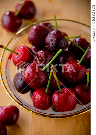 Ripe red cherries in glass bowl. 66282328