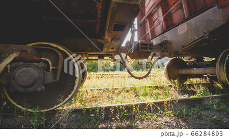 Two old rusty train cars connected with rusty coupler on railway 66284893