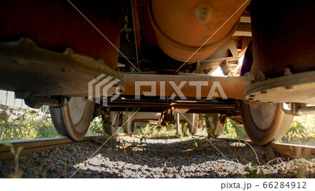 View from the ground on old rusty cargo train wagon on railroad 66284912