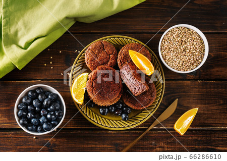 Gluten-free vegan buckwheat muffins on dark wooden table Gluten-free vegan buckwheat muffins on dark wooden table 66286610