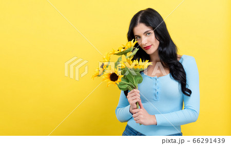 Young woman with sunflowers 66291439