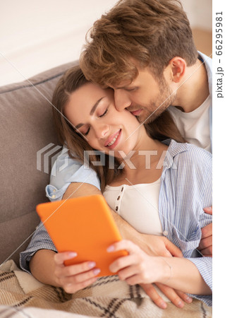 Fair-haired bearded man hugging his wife, woman smiling Fair-haired bearded man hugging his wife, woman smiling 66295981