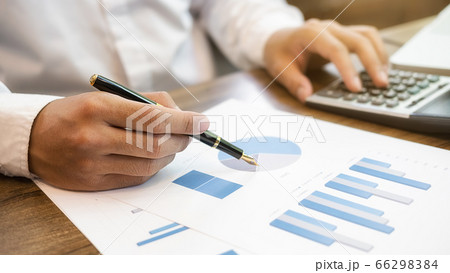Close-up of businessman hand using calculator to calculate business data, accountancy document. Close-up of businessman hand using calculator to calculate business data, accountancy document. 66298384