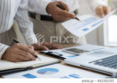 Business team brainstorming and discussing with financial data and report graph. Business team brainstorming and discussing with financial data and report graph. 66298385