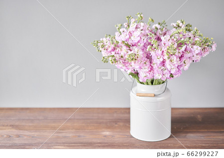 Bouquet of Beautiful lilac mattiola. Spring flowers in vase on wooden table. Flowers delivery. 66299227