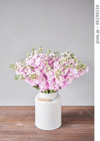 Bouquet of Beautiful lilac mattiola. Spring flowers in vase on wooden table. Flowers delivery. 66299230