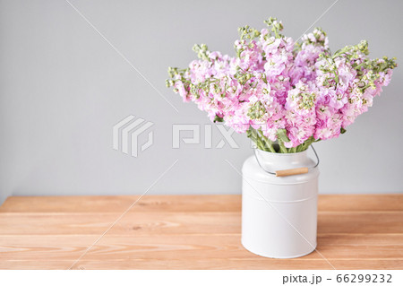 Bouquet of Beautiful lilac mattiola. Spring flowers in vase on wooden table. Flowers delivery. 66299232