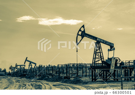 Petroleum concept. Oil pump rig. Oil and gas production. Oilfield site. Pump Jack are running. Drilling derricks for fossil fuels output and crude oil production. Global crisis. War on oil prices. Petroleum concept. Oil pump rig. Oil and gas production. Oilfield site. Pump Jack are running. Drilling derricks for fossil fuels output and crude oil production. Global crisis. War on oil prices. 66300501