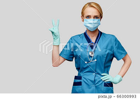 medical doctor nurse woman with stethoscope wearing protective mask and rubber or latex gloves 66300993