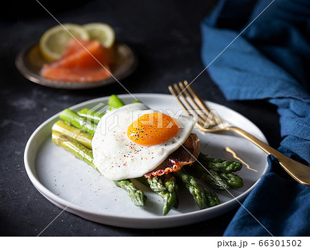 Fried eggs with asparagus, dark moody style Fried eggs with asparagus, dark moody style 66301502