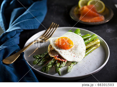 Fried eggs with asparagus, dark moody style 66301503