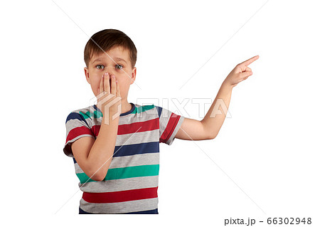 Shocked boy pointing with his finger on something, isolated on white background Shocked boy pointing with his finger on something, isolated on white background 66302948