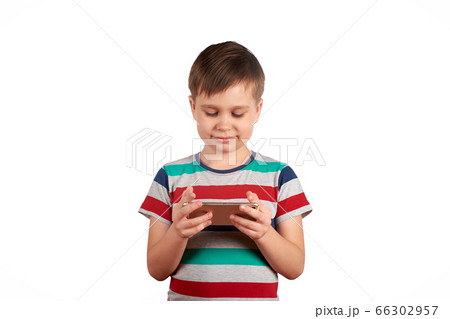 Little kid playing games on smartphone isolated over white background Little kid playing games on smartphone isolated over white background 66302957
