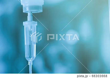 Saline iv bag intravenous drip hospital room,Medical Concept,treatment and injection vitamin natural drug infusion care chemotherapy concept.green light background hospital,Selective focus 66303668