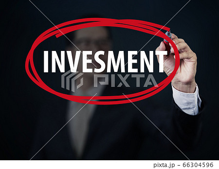 Businessman hand writing "INVESMENT" with red Businessman hand writing "INVESMENT" with red 66304596