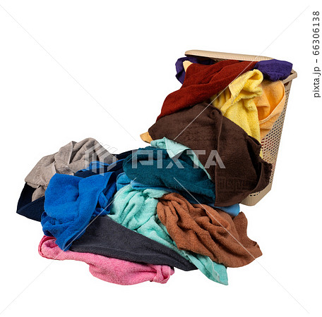 Laundry basket with a pile of towels isolated on 66306138