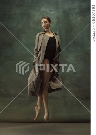 Young graceful tender ballerina on dark studio background 66307293