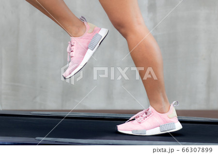 The detail of legs running on a treadmill The detail of legs running on a treadmill 66307899