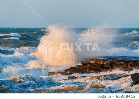 Big waves crash against coastal cliffs. Sea stormの写真素材