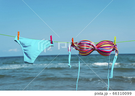 bikini hanging on a clothes line on the beach 66310099