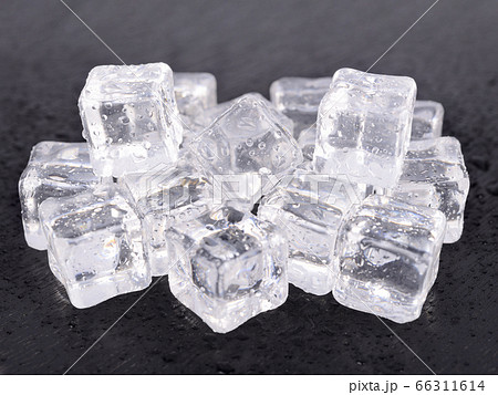 pile of ice cube on wooden black background 66311614
