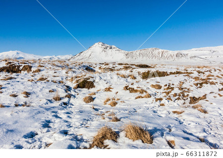 Budakirkja or better known as The Black Church view with blue sky during winter snow, Iceland Budakirkja or better known as The Black Church view with blue sky during winter snow, Iceland 66311872