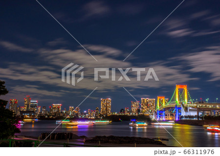 Odaiba, Tokyo, Beautiful and colorful rainbow bridge and Tokyo city night background image, cloudy in motion and left copy space for Title. Odaiba, Tokyo, Beautiful and colorful rainbow bridge and Tokyo city night background image, cloudy in motion and left copy space for Title. 66311976