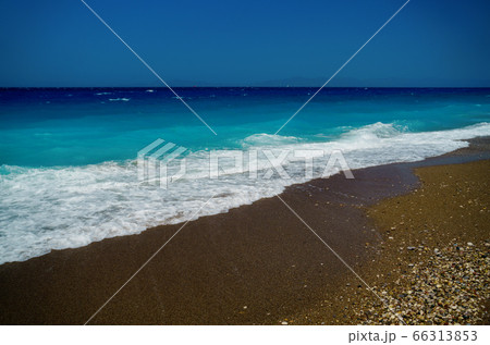 Peaceful sea wave foams on the beach, Aegean Sea, Rhodes, Greece. 66313853