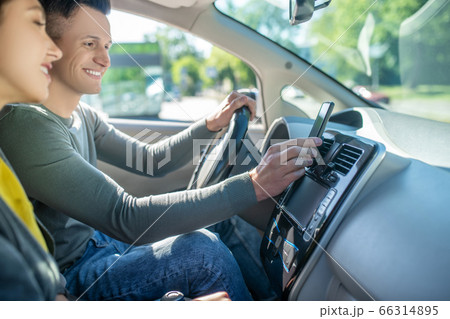 Young couple sitting in the car ready for the test driving Young couple sitting in the car ready for the test driving 66314895