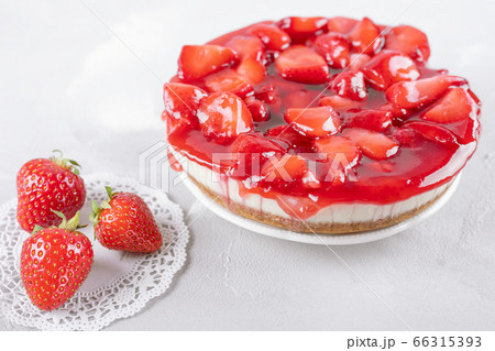 cheesecake with strawberry and fresh berries on gray table 66315393