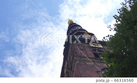COPENHAGEN, DENMARK - JUL 06th, 2015: Our Saviour's Vor Frelsers Kirke - one of Denmark's most famous churches. Serpentine spire was inaugurated in 1752 - a popular pastime to climb 400 steps to top COPENHAGEN, DENMARK - JUL 06th, 2015: Our Saviour's Vor Frelsers Kirke - one of Denmark's most famous churches. Serpentine spire was inaugurated in 1752 - a popular pastime to climb 400 steps to top 66316560