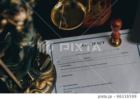 Top view of contract in clipboard lying at office on wooden table with laptop and documents Top view of contract in clipboard lying at office on wooden table with laptop and documents 66316599