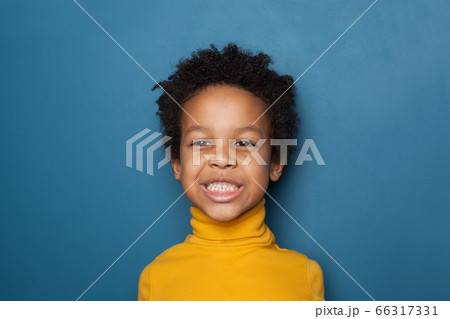 Funny black kid boy on blue background portrait 66317331