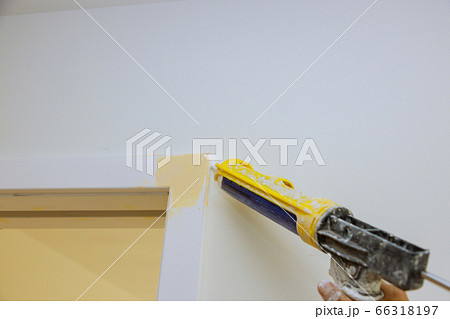 Worker hands on applying silicone sealant with Worker hands on applying silicone sealant with 66318197