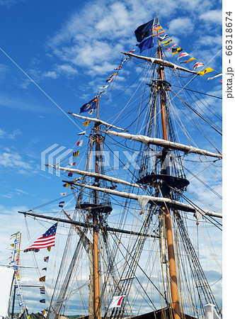 The mast of a large tall boat sitting on the pear 66318674
