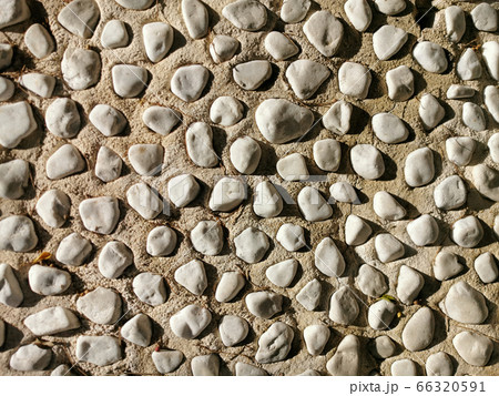 round gray stones in cement as texture, background round gray stones in cement as texture, background 66320591